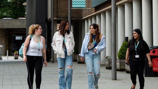 Four female students walking outside Gateway building at High Wycombe campus